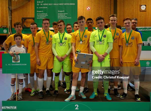 The team of SV Sandhausen celebrates the second place on the podium of the B Juniors German Indoor Football Championship at Sporthalle West on March...