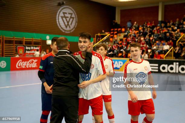 Head coach Ismail Oeztuerk of SC Fortuna Koeln embraces Yusuf Oemek after winning the final match between SV Sandhausen and Fortuna Koeln 1-5 of the...