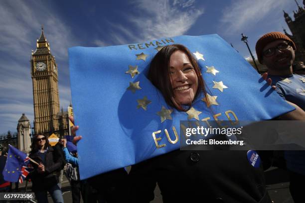 Protester wears a 'Remain United' European Union flag sign on her head during a Unite for Europe march to protest Brexit in central London, U.K., on...