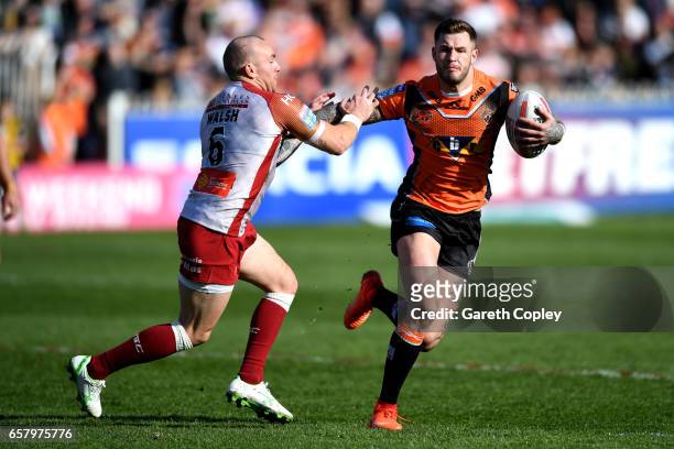 Zak Hardaker of Castleford hands off Luke Walsh of Catalans during the Betfred Super League match between Castleford Tigers and Catalans Dragons at...