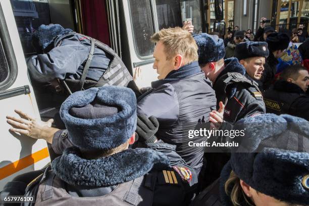 Police officers detain anti-corruption campaigner and opposition figure Alexei Navalny during an opposition rally on March 26, 2017 in Moscow.