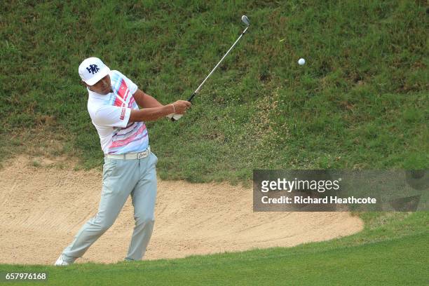 Hideto Tanihara of Japan plays a shot out of a bunker on the 3rd hole of his match during the semifinals of the World Golf Championships-Dell...