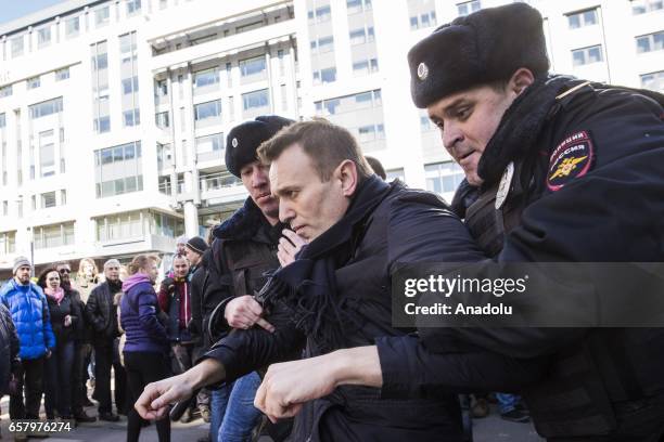 Police officers detain anti-corruption campaigner and opposition figure Alexei Navalny during an opposition rally on March 26, 2017 in Moscow.