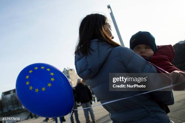 Child carried from his mom holds a ballon with the colours of the European Union in the district of Friedrichshain-Kreuzberg in Berlin, Germany on...