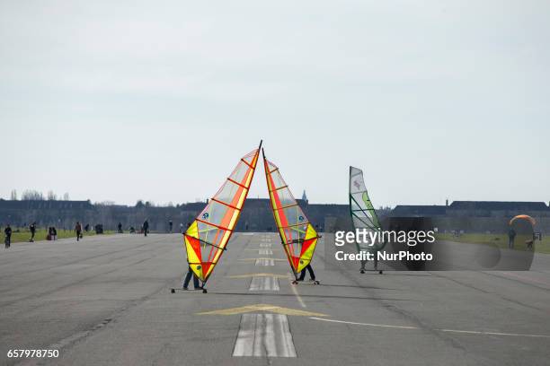 People are pictured as they practice land windsurfing at the Tempelhofer Feld park in Berlin, Germany on March 25, 2017.
