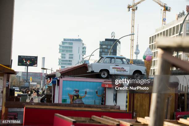 People walk in the first spring sun in the park of the East Side Gallery in the district of Friedrichshain-Kreuzberg in Berlin, Germany on March 25,...