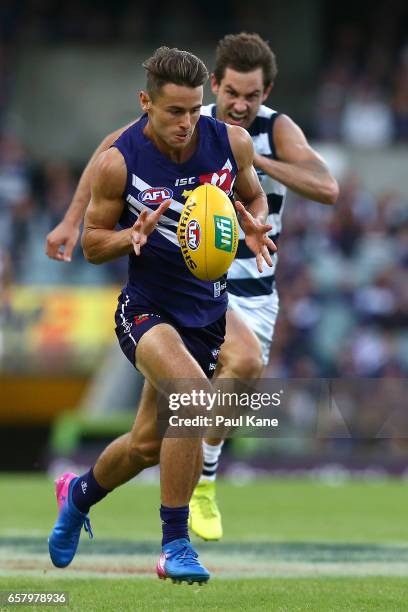 Lachlan Weller of the Dockers runs with the ball during the round one AFL match between the Fremantle Dockers and the Geelong Cats at Domain Stadium...