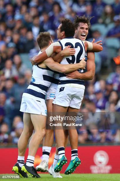 Lincoln McCarthy, Steven Motlop and Tom Hawkins of the Cats celebrate a goal during the round one AFL match between the Fremantle Dockers and the...
