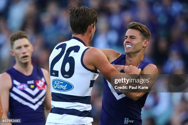 Lachie Weller of the Dockers remonstrates with Tom Hawkins of the Cats during the round one AFL match between the Fremantle Dockers and the Geelong...