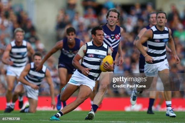 Steven Motlop of the Cats runs with the ball during the round one AFL match between the Fremantle Dockers and the Geelong Cats at Domain Stadium on...