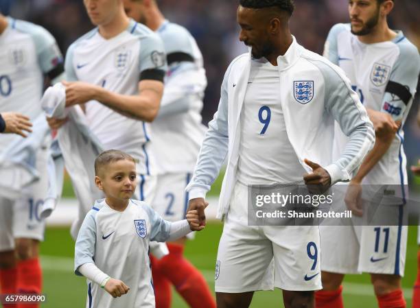 Jermaine Defoe of England and England mascot Bradley Lowery line up prior to the FIFA 2018 World Cup Qualifier between England and Lithuania at...