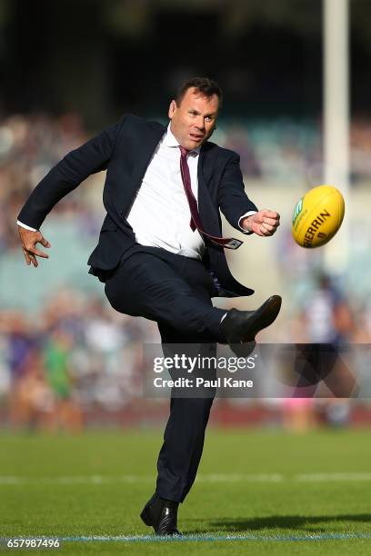 Fox Sports commentator David King attempts to kick the ball from the 50 meter line for charity before the round one AFL match between the Fremantle...