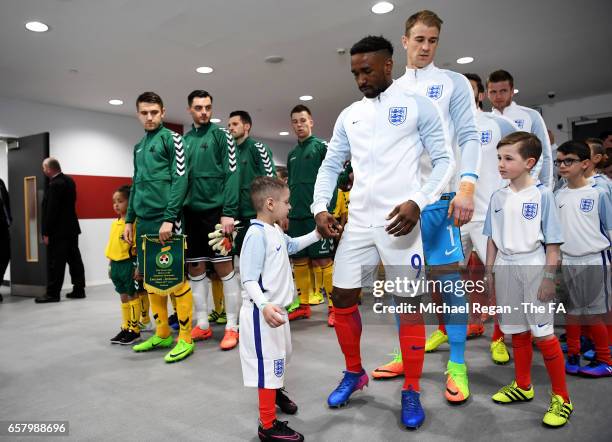 England mascot Bradley Lowery prepares to walk out onto the pitch with Jermain Defoe of England during the FIFA 2018 World Cup Qualifier between...