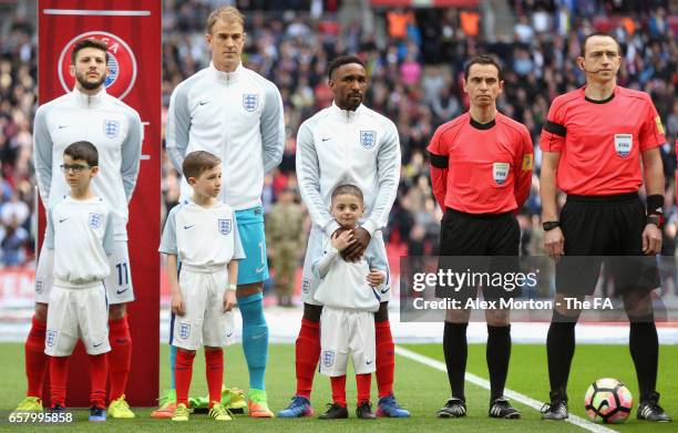 Jermaine Defoe of England and England mascot Bradley Lowery line up prior to the FIFA 2018 World Cup Qualifier between England and Lithuania at...