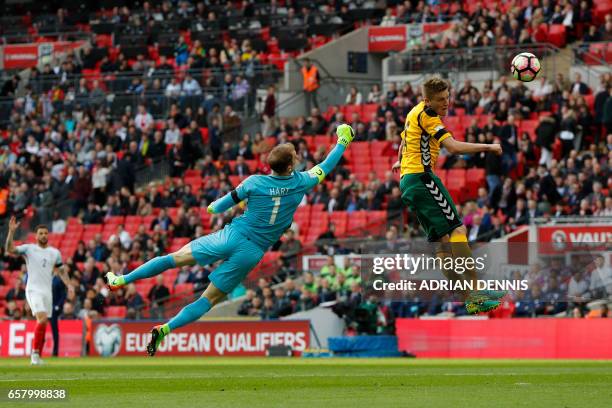 England's goalkeeper Joe Hart vies for the ball with Lithuania's midfielder Vykintas Slivka during the World Cup 2018 qualification football match...