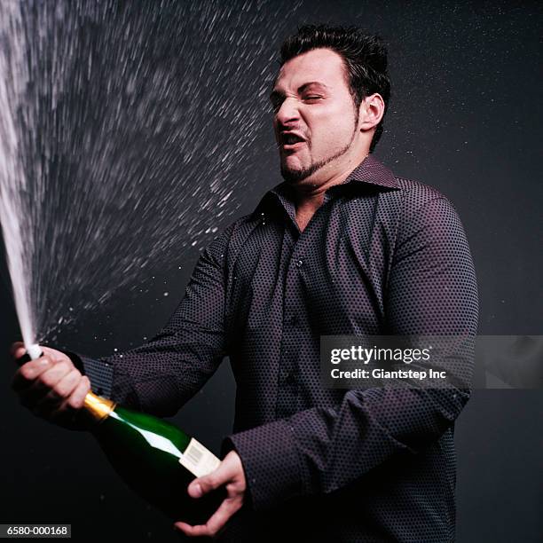 man opening champagne - spraying champagne stock pictures, royalty-free photos & images