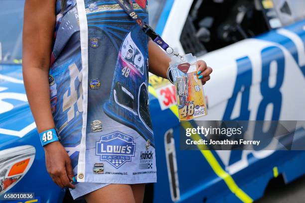 Fan stands in front of the car of Jimmie Johnson, driver of the Lowe's Chevrolet, before the Monster Energy NASCAR Cup Series Auto Club 400 at Auto...