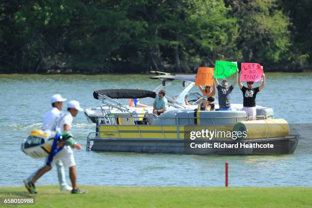 Fans cheer as Hideto Tanihara of Japan walks on the 14th hole of his match during the semifinals of the World Golf Championships-Dell Technologies...