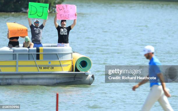 Fans cheer as Dustin Johnson walks on the 14th hole of his match during the semifinals of the World Golf Championships-Dell Technologies Match Play...