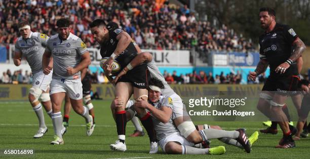 Sean Maitland of Saracens is tackled by Luke Charteris and Francois Louw during the Aviva Premiership match between Saracens and Bath at Allianz Park...