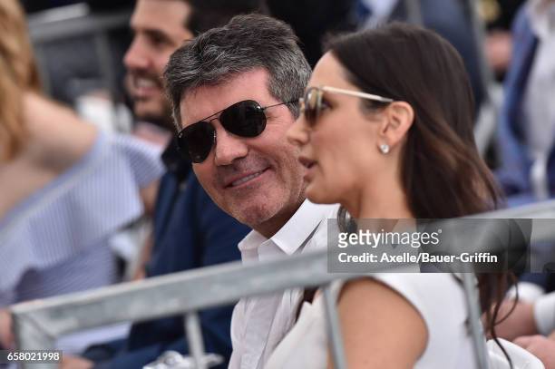 Producer Simon Cowell and Lauren Silverman attend the ceremony honoring Haim Saban with star on the Hollywood Walk of Fame on March 22, 2017 in...