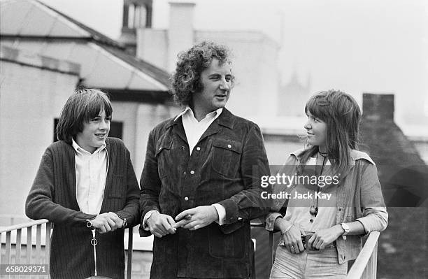 English film director Michael Winner with actors Christopher Ellis and Verna Harvey , who play Miles and Flora in his film 'The Nightcomers', UK,...