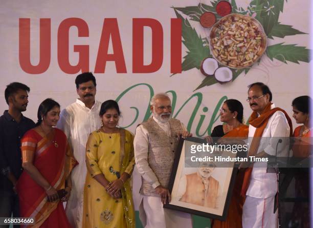 Prime Minister Narendra Modi being presented his portrait by Union Minister Venkaiah Naidu and others on the occasion of "Ugadi" according to Hindu...