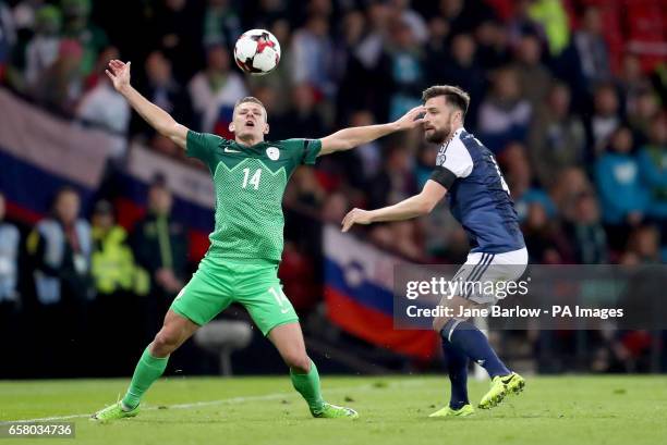 Scotland's Russell Martin and Slovenia's Roman Bezjak battle for the ball during the World Cup Qualifying match at Hampden Park, Glasgow.