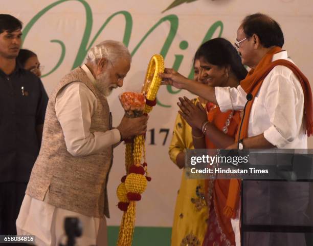 Prime Minister Narendra Modi being honoured in traditional way by Union Minister Venkaiah Naidu and others on the occasion of "Ugadi" according to...