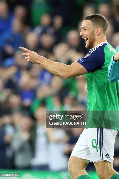 Northern Ireland's forward Conor Washington celebrates after scoring their second goal during the World Cup 2018 qualification football match between...