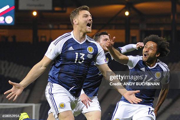 Scotland's striker Chris Martin celebrates scoring the only goal with Scotland's defender Ikechi Anya during the World Cup 2018 qualification...