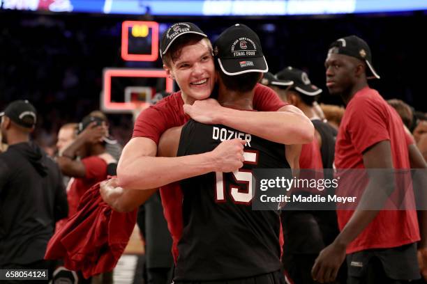 Maik Kotsar and PJ Dozier of the South Carolina Gamecocks celebrate after defeating the Florida Gators with a score of 77 to 70 to win the 2017 NCAA...