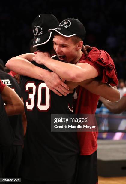 Maik Kotsar and Chris Silva of the South Carolina Gamecocks celebrate after defeating the Florida Gators with a score of 77 to 70 to win the 2017...