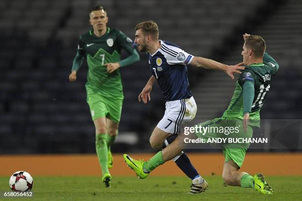 Slovenia's midfielder Valter Birsa vies with Scotland's midfielder James Morrison during the World Cup 2018 qualification football match between...