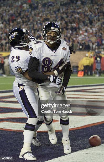 Jermaine Lewis of the Baltimore Ravens is congratulated by Chuck Evans after scoring a 84 yard touchdown against the New York Giants during Super...