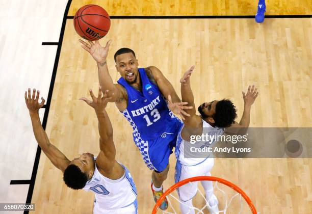 Isaiah Briscoe of the Kentucky Wildcats shoots against Nate Britt and Joel Berry II of the North Carolina Tar Heels in the first half during the 2017...