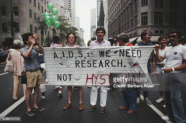 Marchers on a Gay Pride parade through Manhattan, New York City, carry a banner which reads 'A.I.D.S.: We need research, not hysteria!', June 26,...