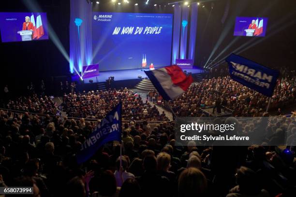 Supporters wave flags as French presidential candidate Marine Le Pen holds a rally meeting at Zenith on March 26, 2017 in Lille, France. The first...