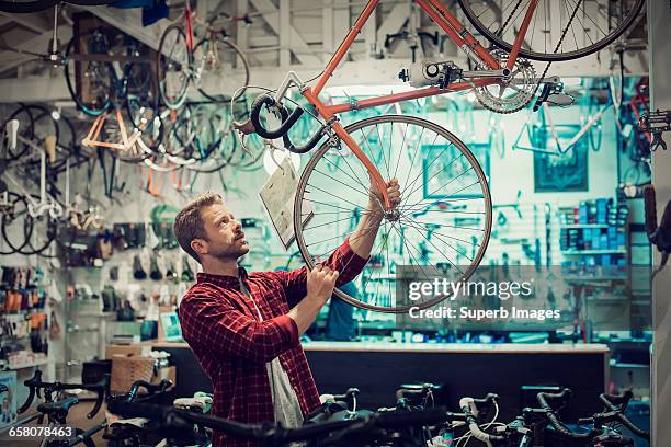 customer shops for bike - small business stock-fotos und bilder
