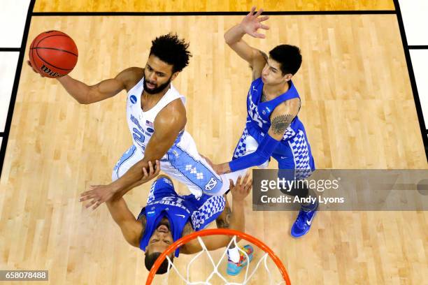 Joel Berry II of the North Carolina Tar Heels shoots against Isaiah Briscoe and Derek Willis of the Kentucky Wildcats in the second half during the...