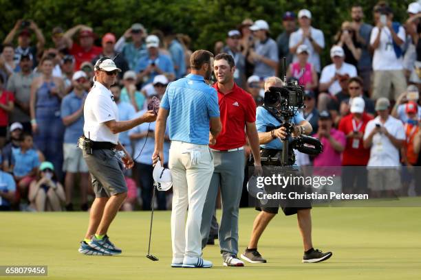 Dustin Johnson shakes hands with Jon Rahm of Spain after winning the World Golf Championships-Dell Technologies Match Play at the Austin Country Club...