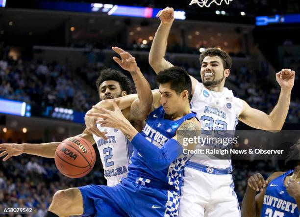 North Carolina's Joel Berry II and Luke Maye battles for a rebound with Kentucky's Derek Willis during the first half of the NCAA Tournament South...