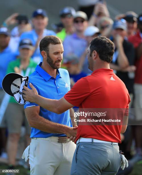 Dustin Johnson shakes hands with Jon Rahm of Spain after winning the final match of the World Golf Championships-Dell Technologies Match Play 1 up on...