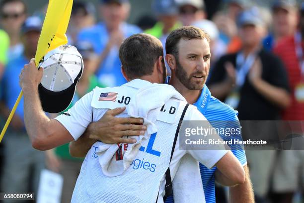 Dustin Johnson celebrates with his caddie Austin Johnson after winning the final match of the World Golf Championships-Dell Technologies Match Play...