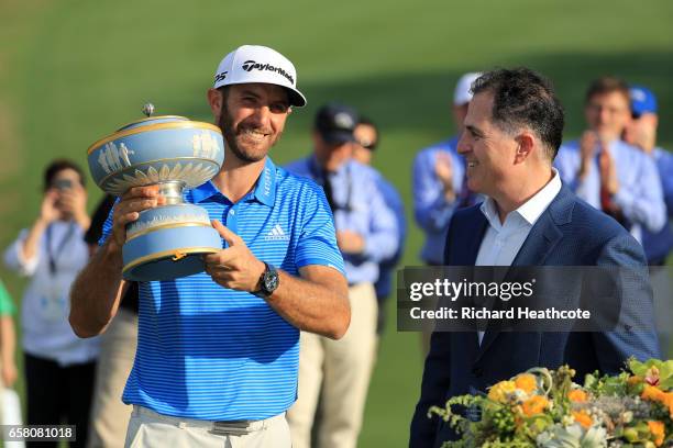 Dustin Johnson celebrates with the trophy after winning the World Golf Championships-Dell Technologies Match Play at the Austin Country Club on March...