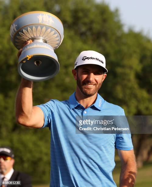 Dustin Johnson celebrates with the trophy after winning the World Golf Championships-Dell Technologies Match Play at the Austin Country Club on March...