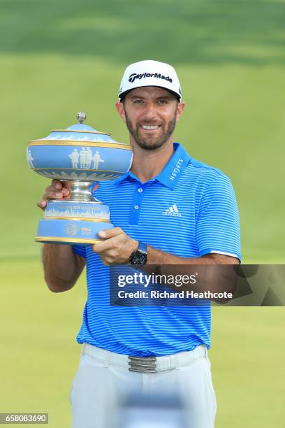 Dustin Johnson poses with the trophy after winning the World Golf Championships-Dell Technologies Match Play at the Austin Country Club on March 26,...