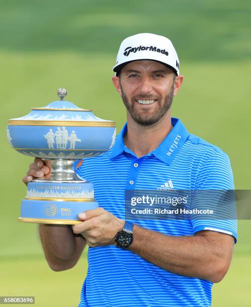 Dustin Johnson poses with the trophy after winning the World Golf Championships-Dell Technologies Match Play at the Austin Country Club on March 26,...