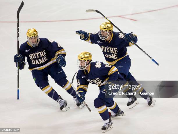 Andrew Oglevie of the Notre Dame Fighting Irish celebrates his overtime winning goal against the Massachusetts Lowell River Hawks during the NCAA...