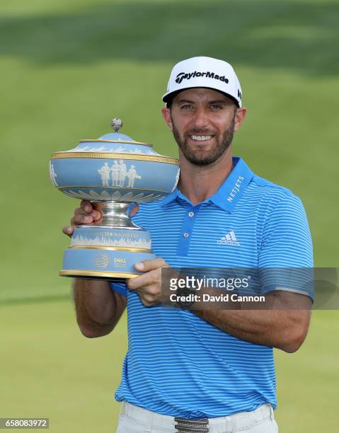 Dustin Johnson of the United States holds the Walter Hagen Trophy after his 1 up win in his match against John Rahm of Spain during the final of the...